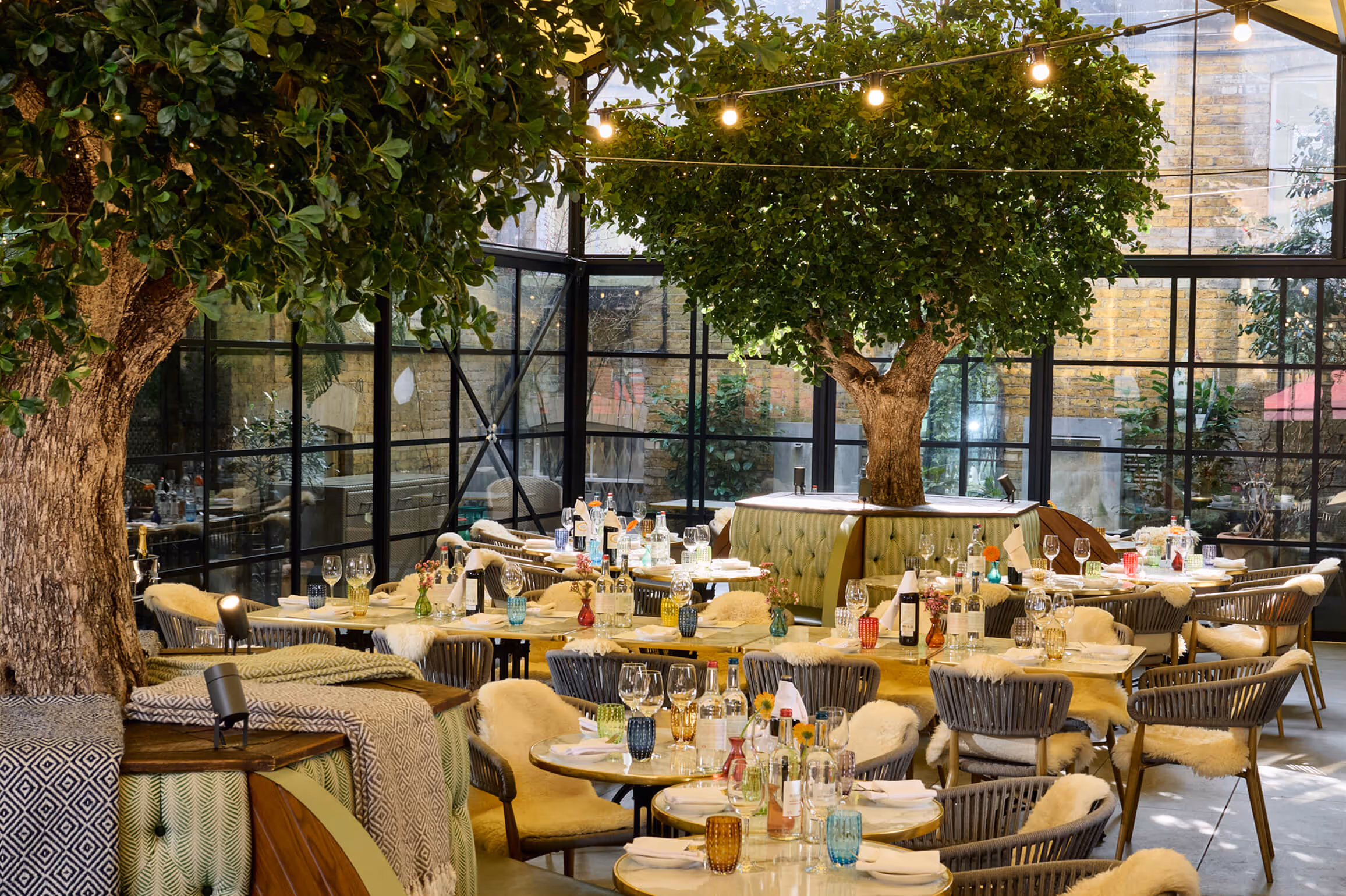 A fully laid -up table in The Private Room at Stanley's Chelsea with a floral illustrated border