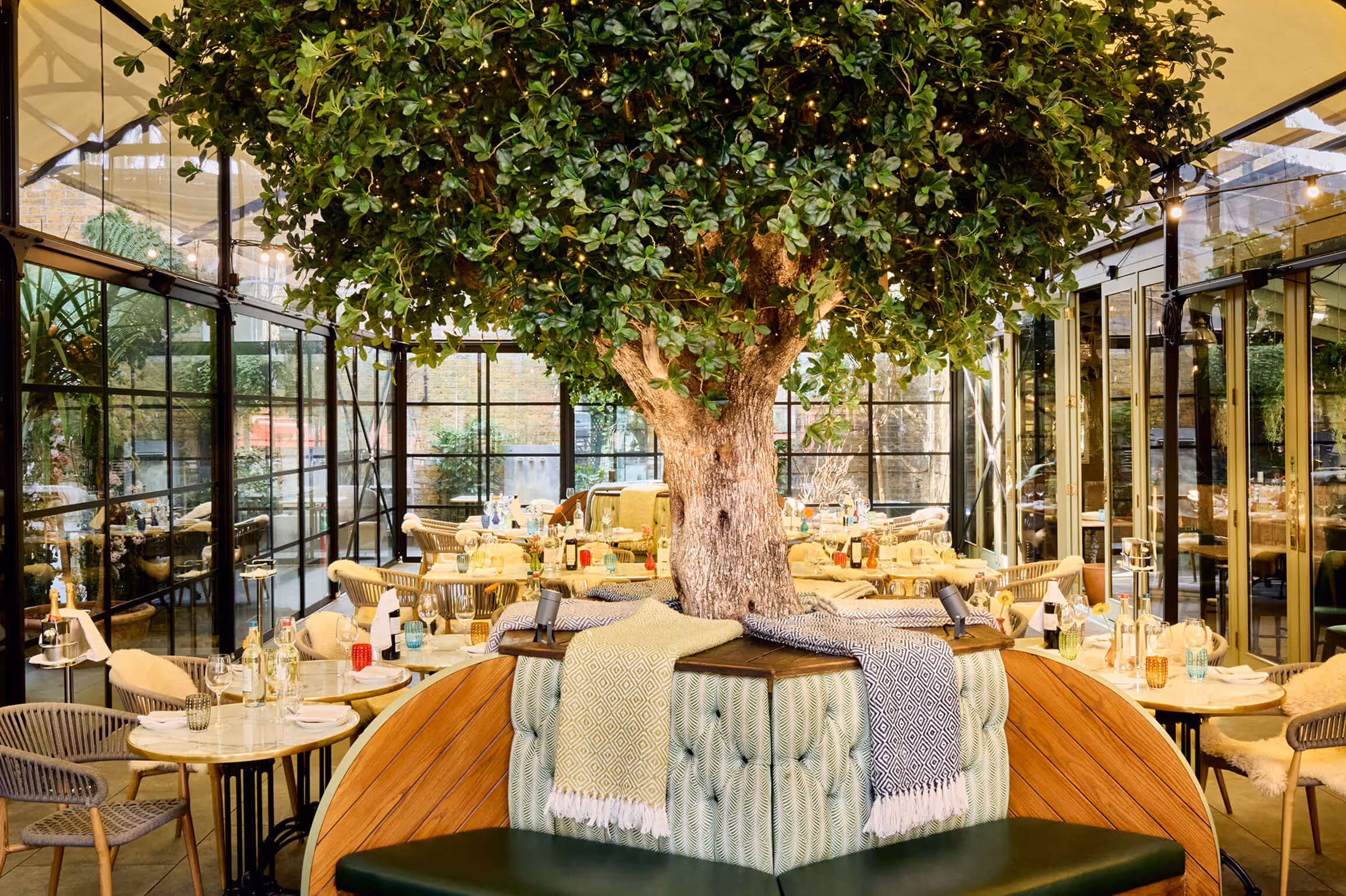 A fully laid -up table in The Private Room at Stanley's Chelsea with a floral illustrated border