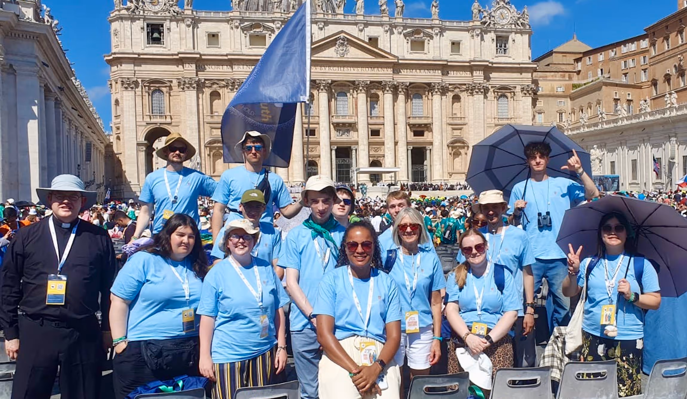 Photo shows six young adults posing happily in front of the Trevi Fountain.