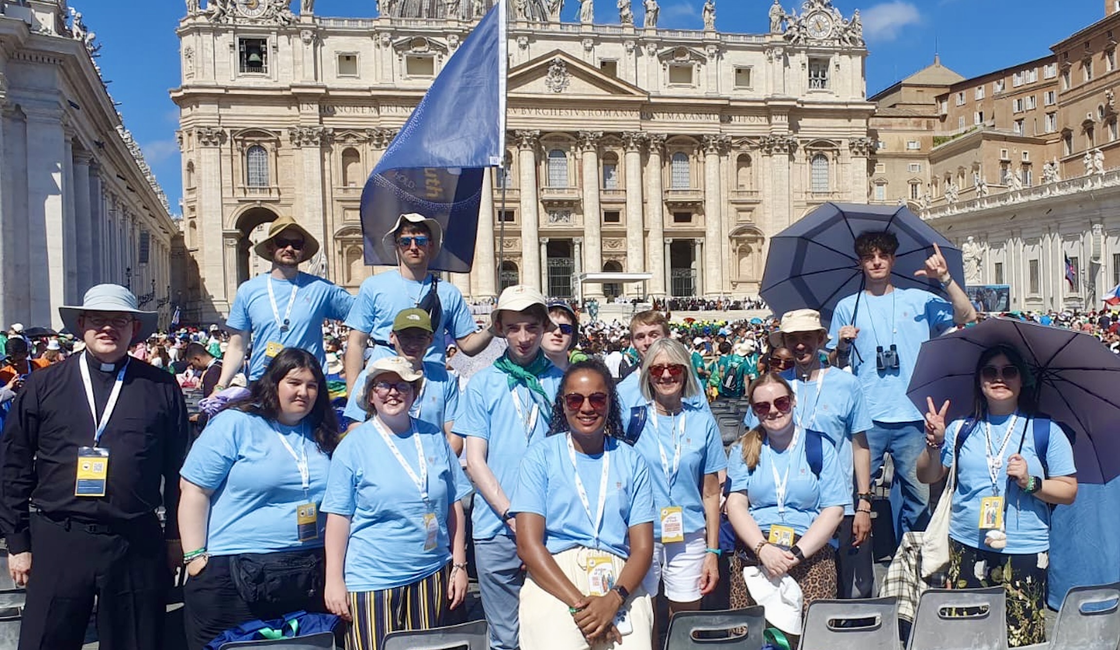Photo shows six young adults posing happily in front of the Trevi Fountain.