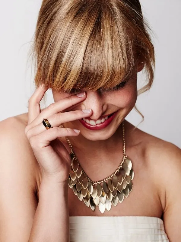 Woman wearing a gold statement necklace