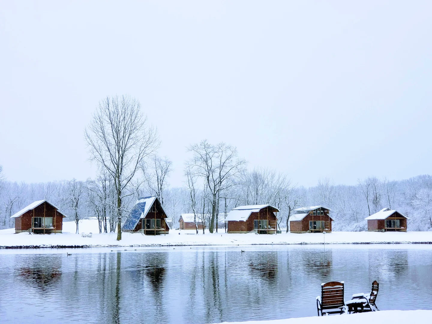 View of back side of lake front cabins at serenity springs on snowy winter afternoon
