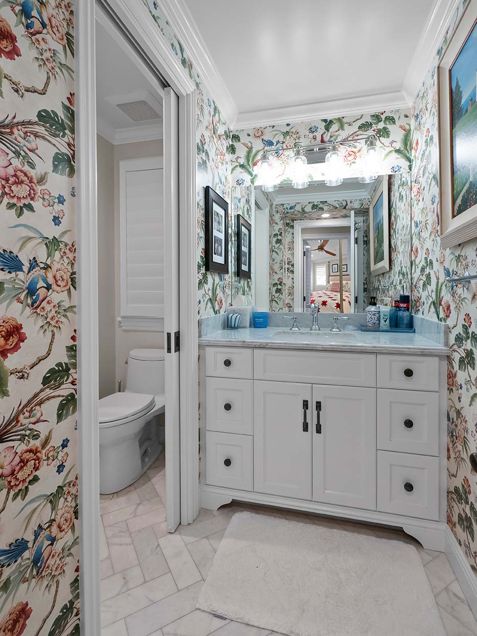 Bathroom at 220 Collins with botanical wallpaper, a marble-top vanity, and a separate water closet