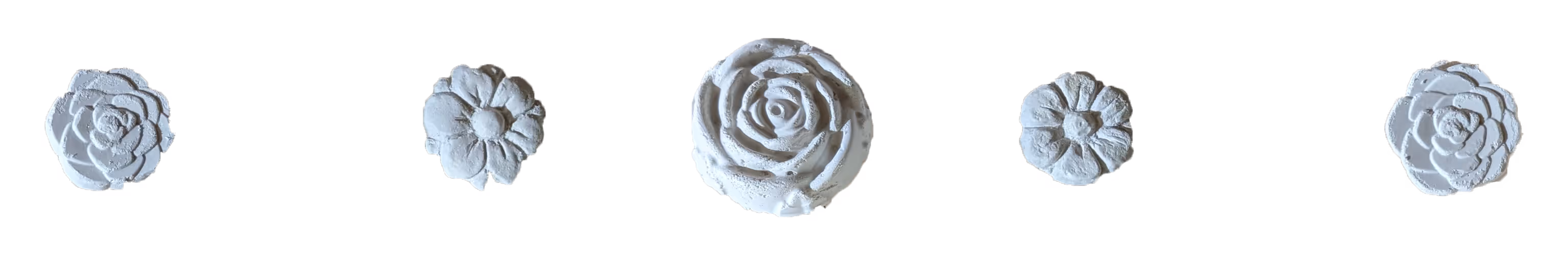 Five white plaster flowers