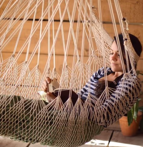 Sara laying down in her hammock chair
