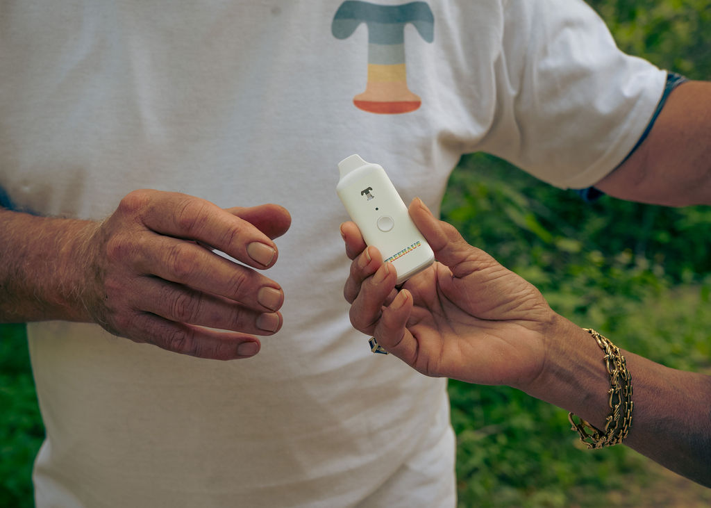 A Treehaus all-in-one handed from one person to another
