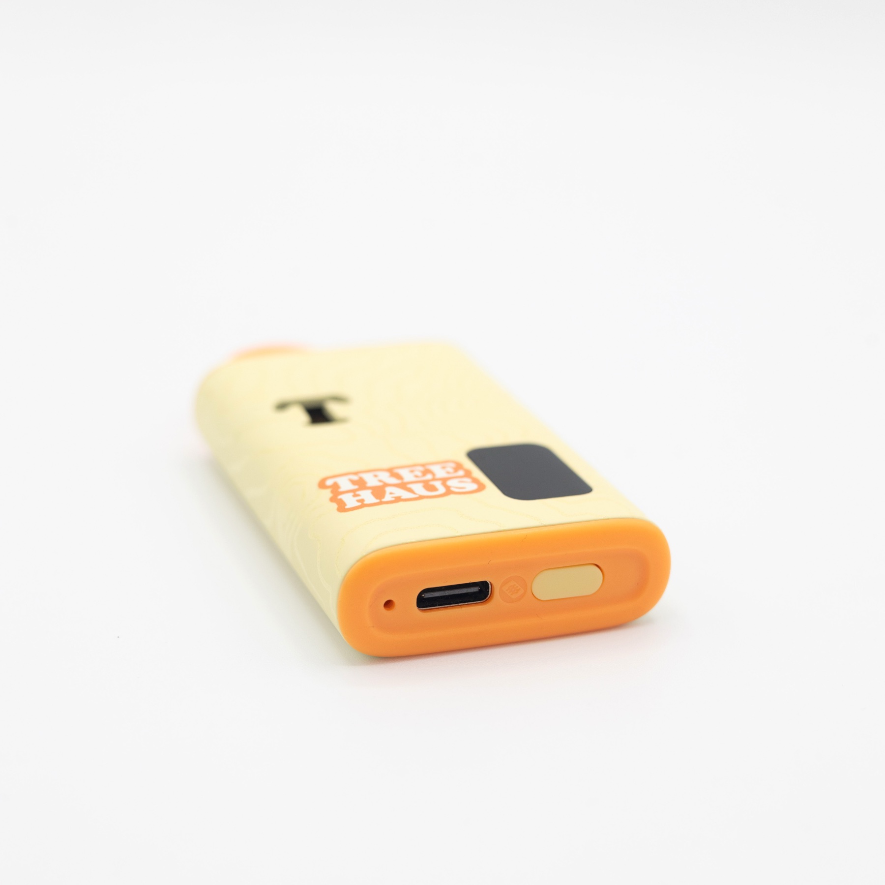 The TreeHash all-in-one on its side, showing the USB-C port and preheat button in the orange base