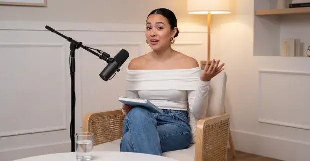 Podcast-style AI Avatar presenter speaking into a microphone in a studio setup.