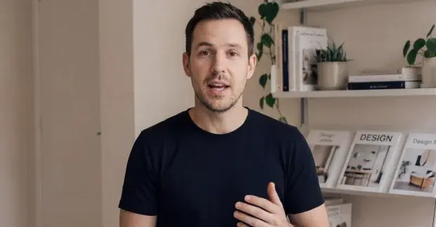 Talking-head AI Avatar presenter delivering a scripted message in a minimalist workspace.