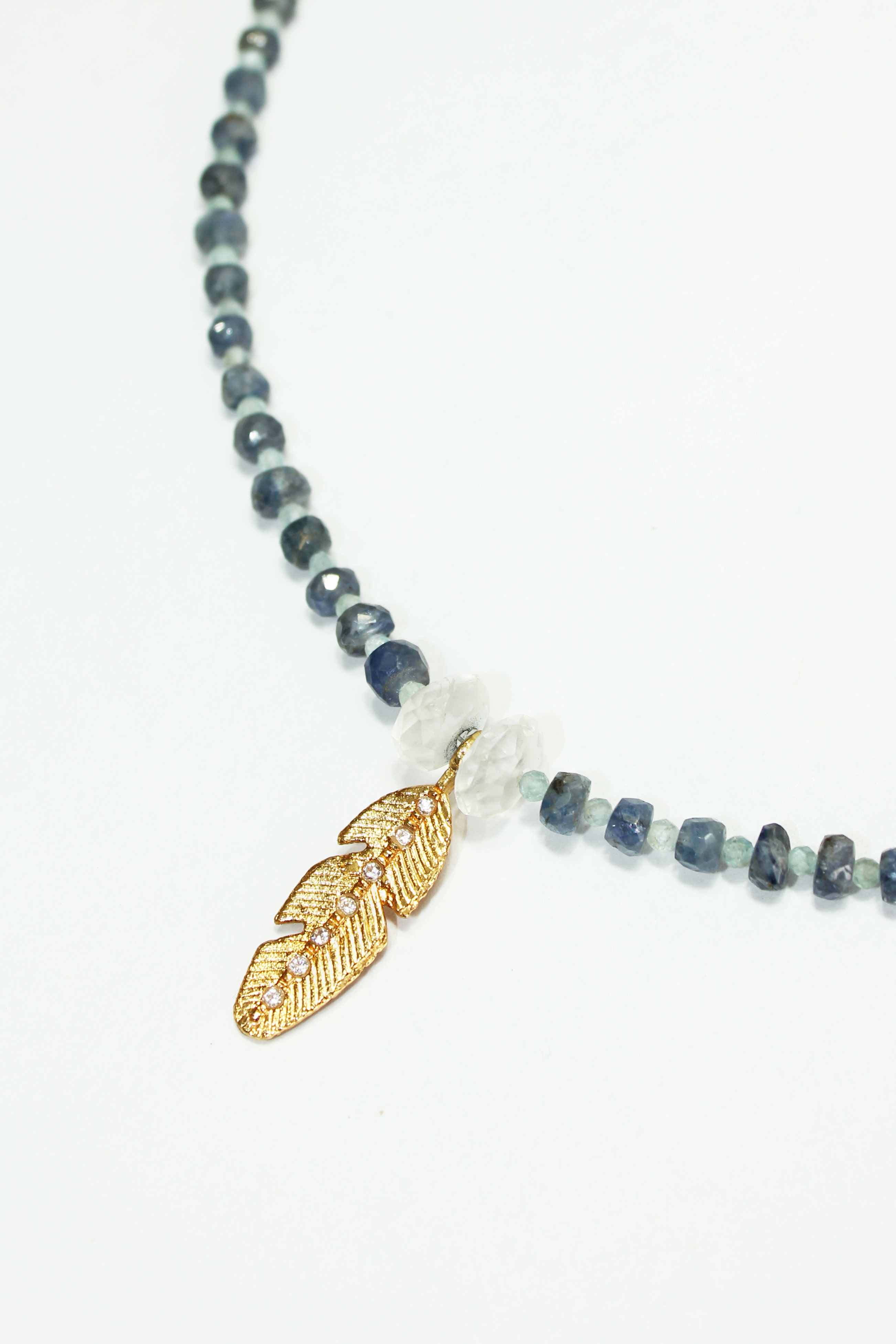 Blue sapphire and aquamarine feather necklace in gold plated silver.