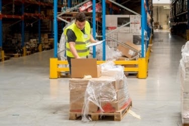 Warehouse employee inspecting the shipment