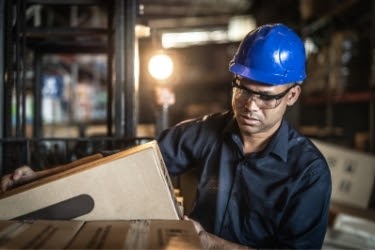 Man picking up a box