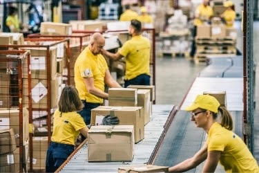 People working at a warehouse moving boxes.