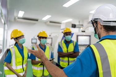 Manager teaching safety inside the warehouse