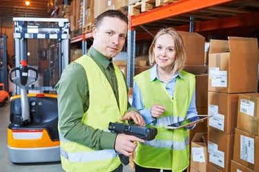 Warehouse employees using digital equipment