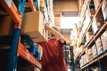 Warehouse worker picking a box