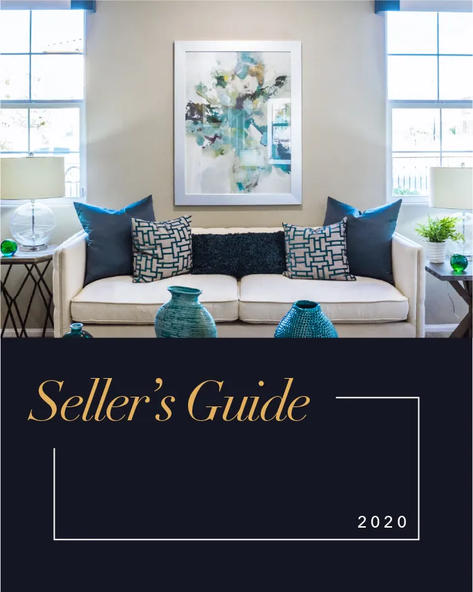 Modern living room with a beige sofa adorned with blue and patterned cushions, two side tables with lamps and decorative items, a colorful abstract painting above the sofa, and large windows letting in natural light, with text overlay reading 'Seller’s Guide 2020'.