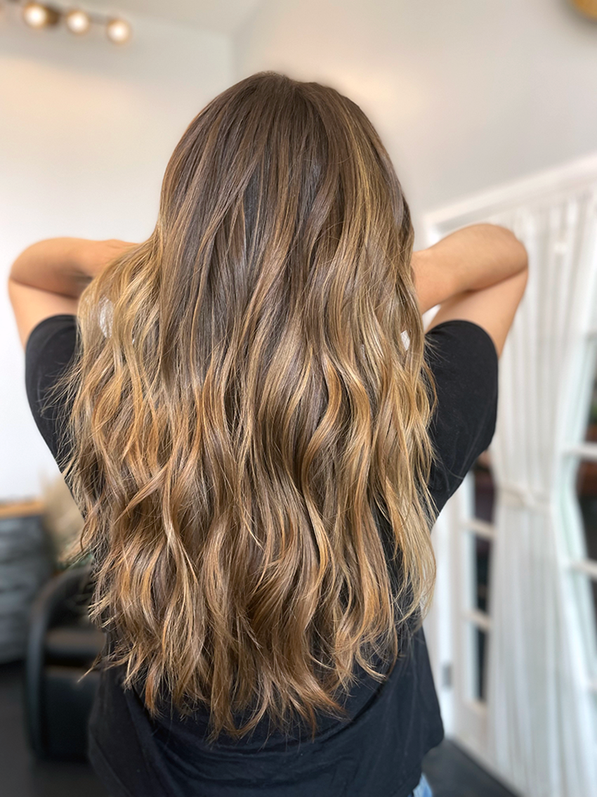 Golden balayage and sun kissed color has us running for the surf. Hair by Sophie