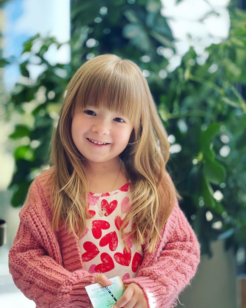 kid with bangs and haircut