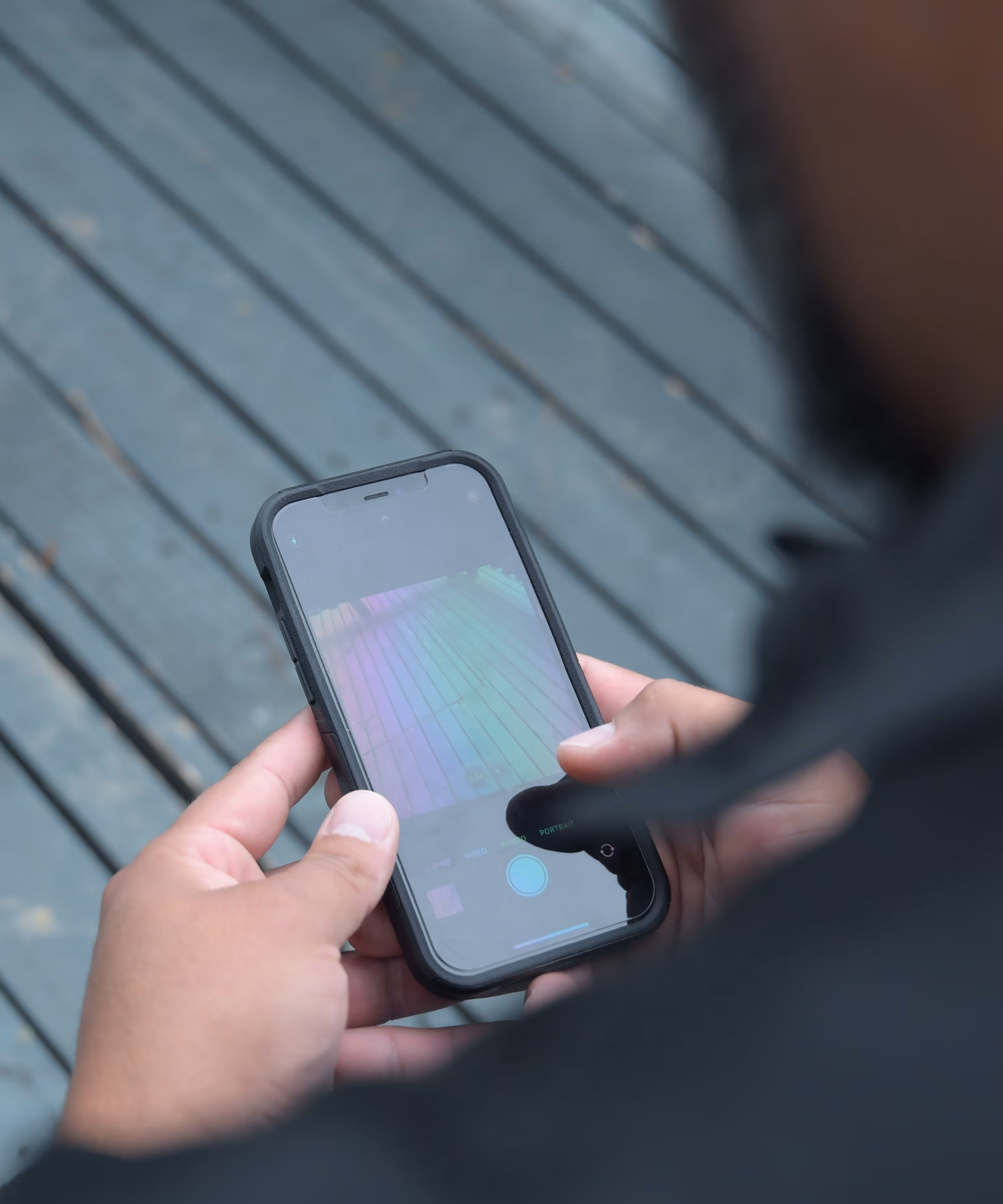 A person holding a cell phone in their hand.