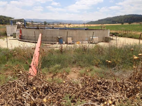 In Israel, a red pipeline means the water is unsafe to drink. Here a pipeline carries locally treated sewage to a holding pond, where it will be pumped out for irrigation.
