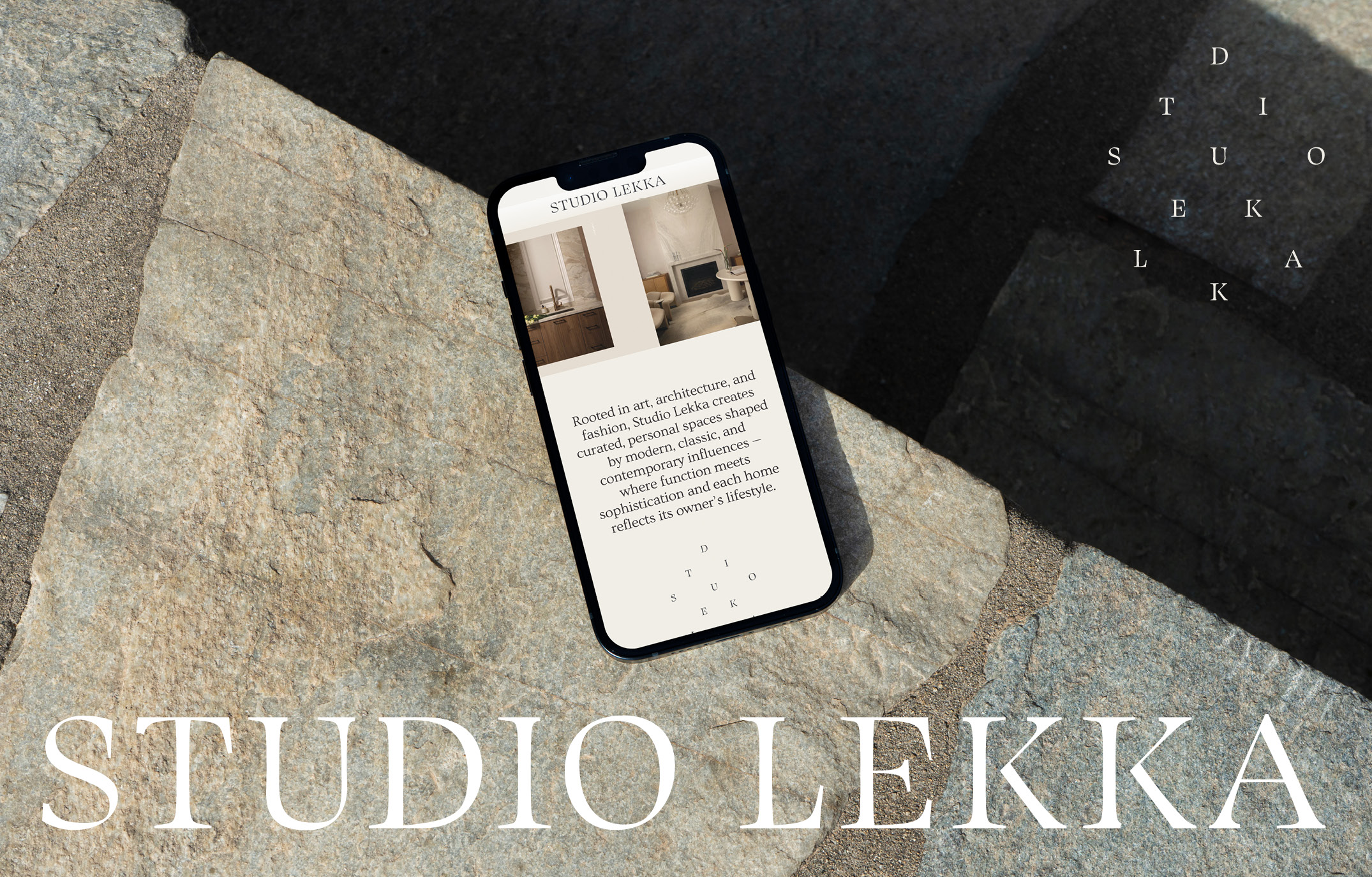 The modified Studio Lekka wordmark shown on a phone resting on a slab of stone.
