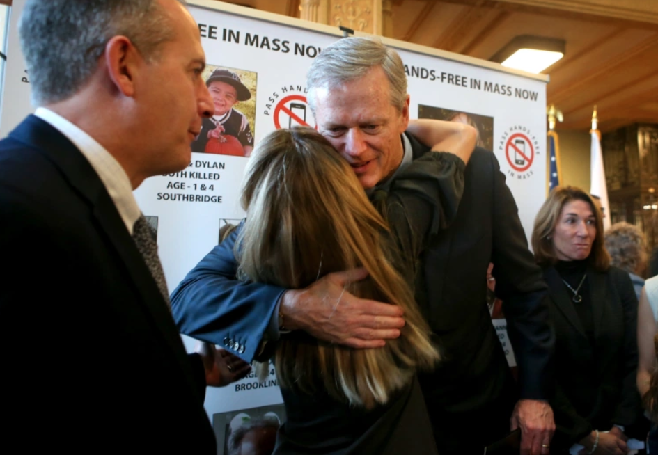 Baker signs bill to ban hand-held cell phones while driving