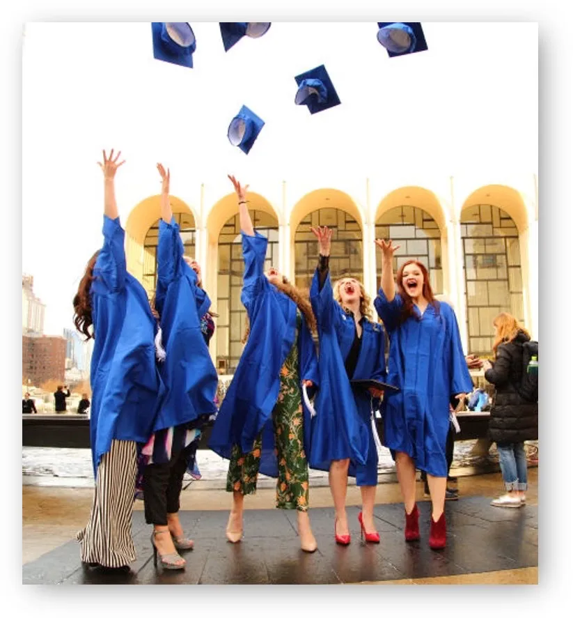 Graduates throwing their mortarboard hats in the air at graduation.