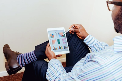 Man reviewing metrics on tablet