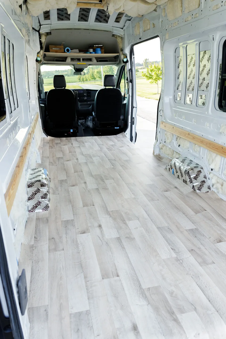 Sheet vinyl flooring sitting in the back of an otherwise empty cargo van