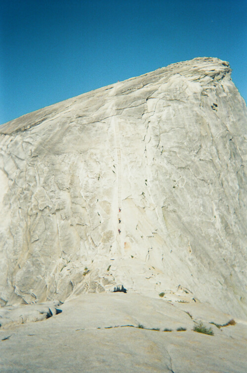 Looking up from the base of Half Dome at the cables with a few people making the ascent