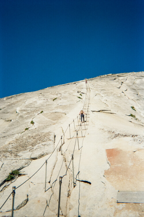 Looking up the Half Dome cables at a hiker ascending