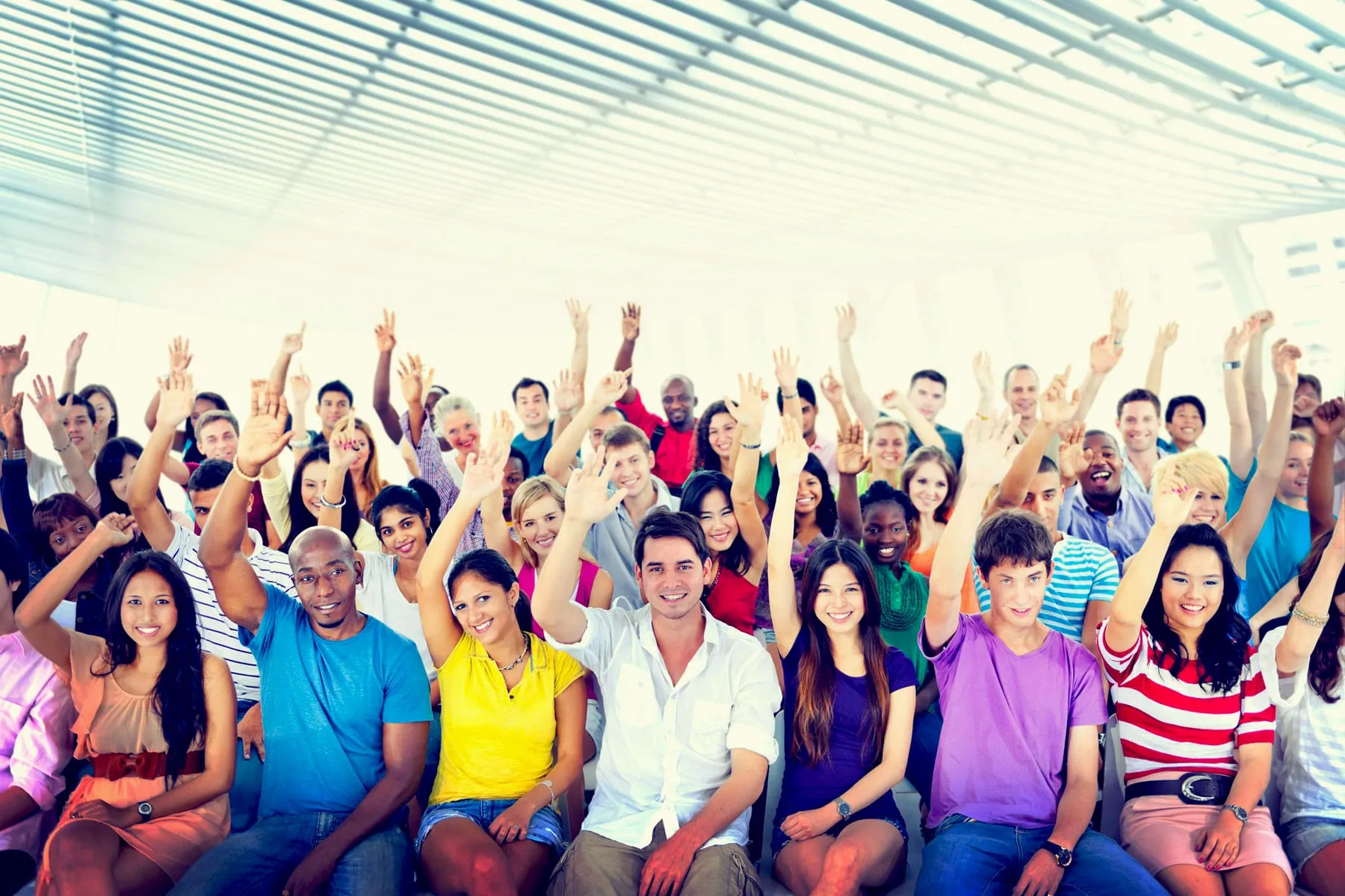 people raising hands to volunteer