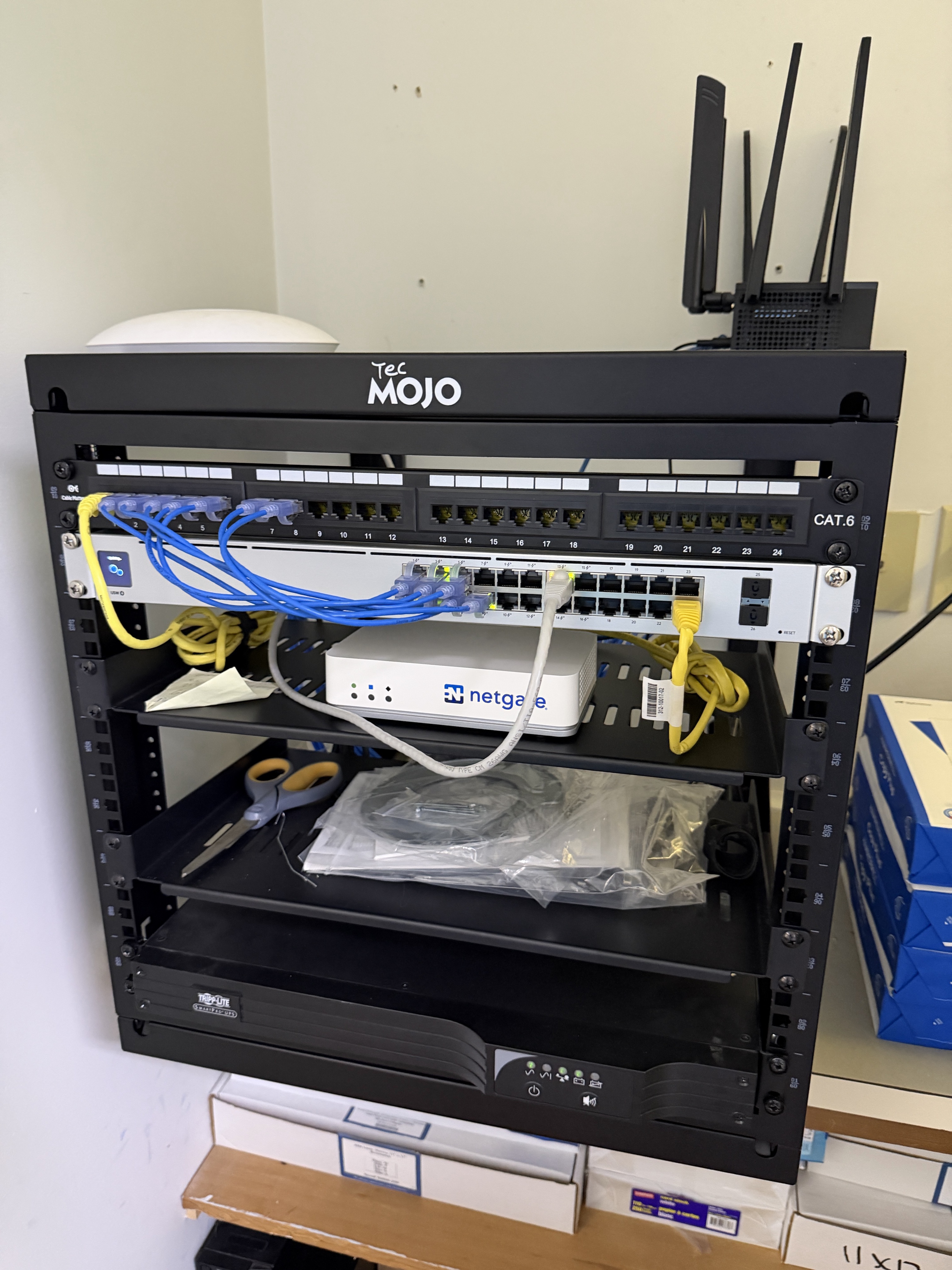 Completed small business network rack upgrade featuring a Ubiquiti UniFi switch, Cat6 patch panel, and organized network cabling.