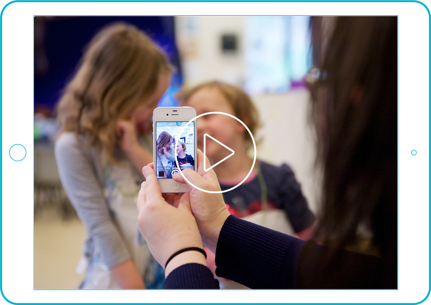 Teacher taking photo of toddlers
