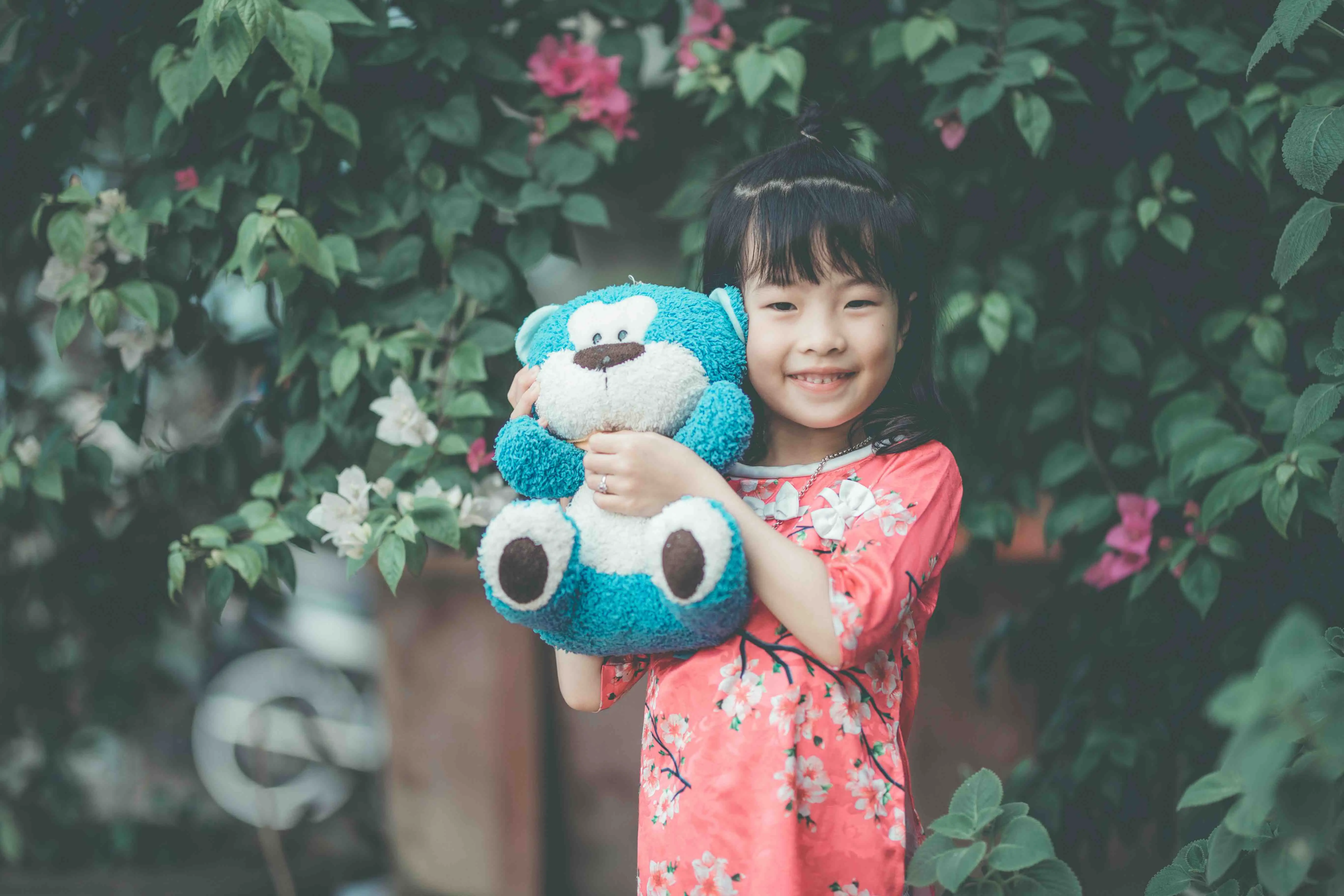 young girl with toy bear