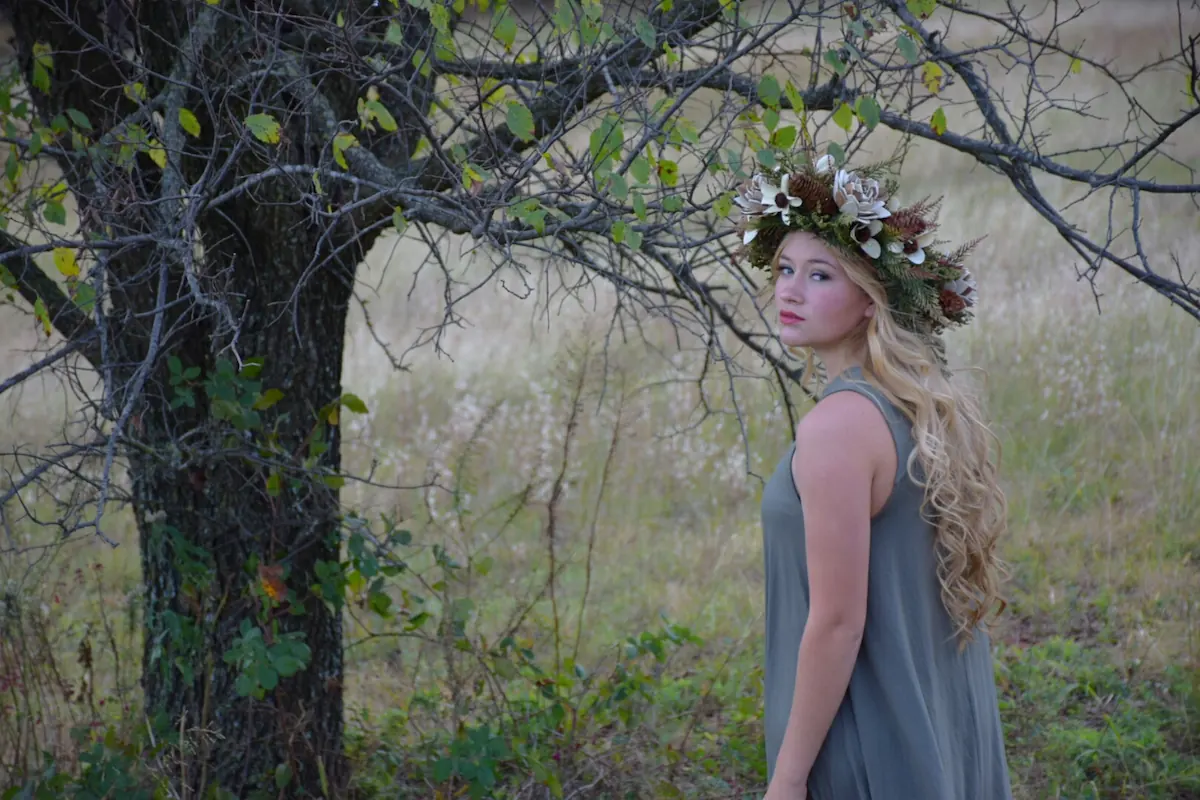 Woman in the woods wearing flower crown.