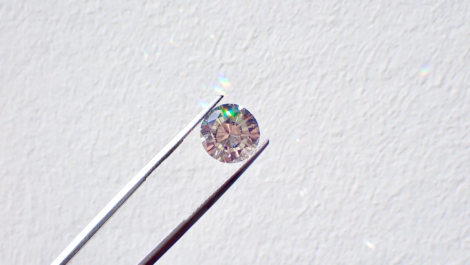 A clear diamond acting as a prism in the light.