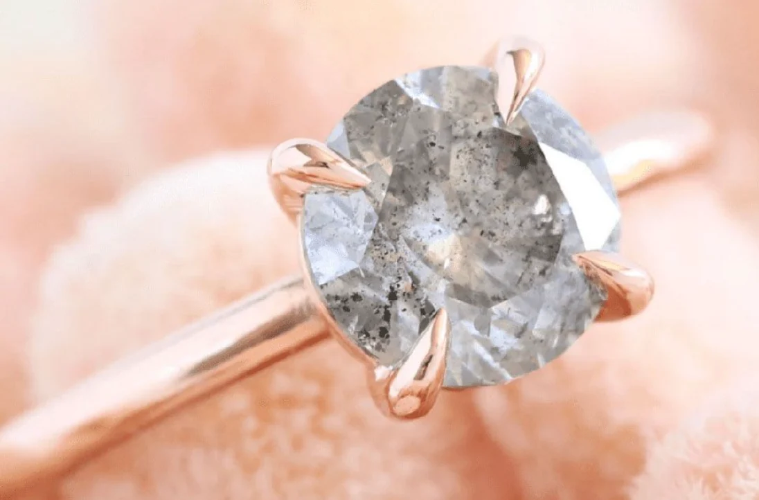 Rose gold ring with peppered diamond.