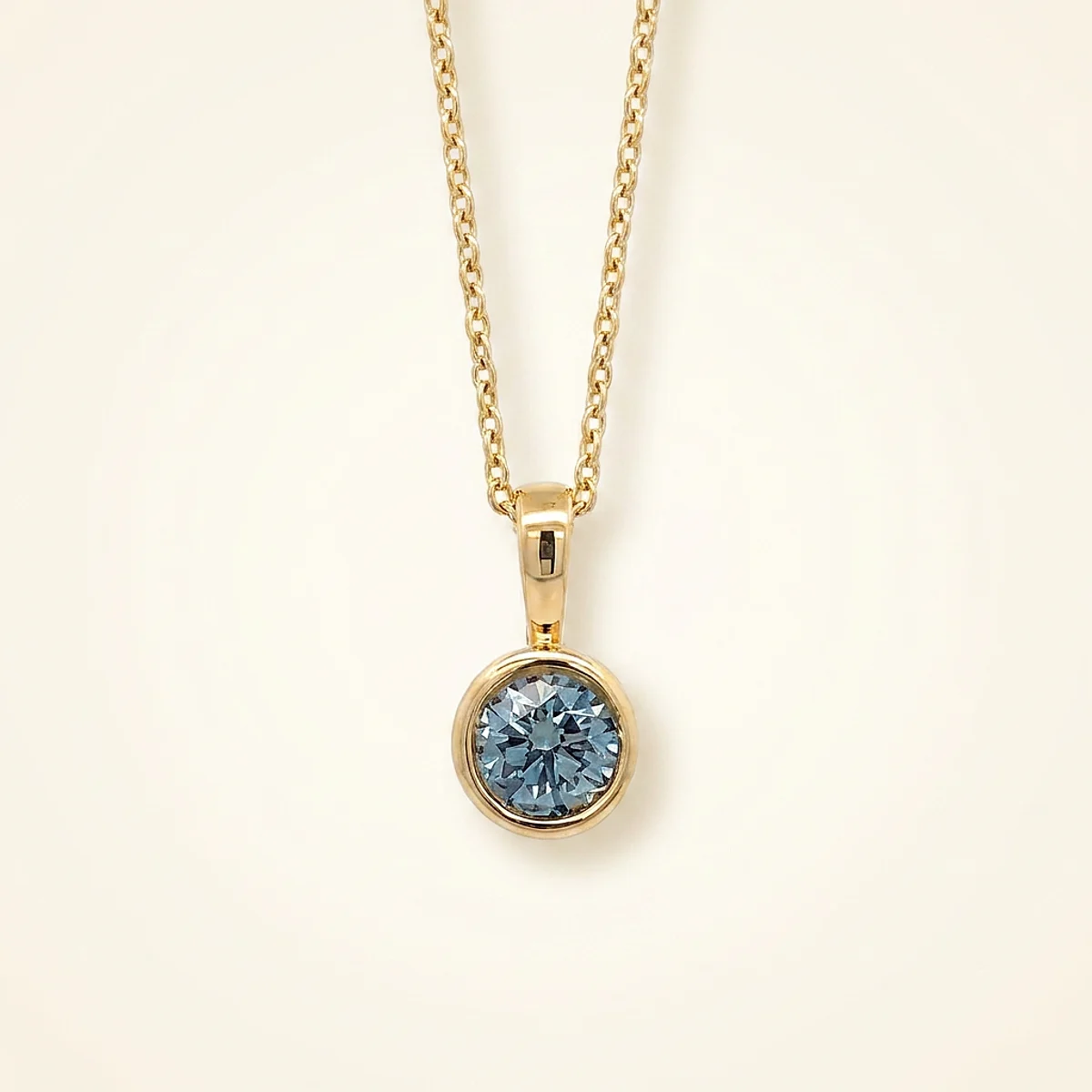 A .4ct blue round diamond on a yellow gold pendant, custom-designed by Eterneva to honor the remarkable Ritvik.