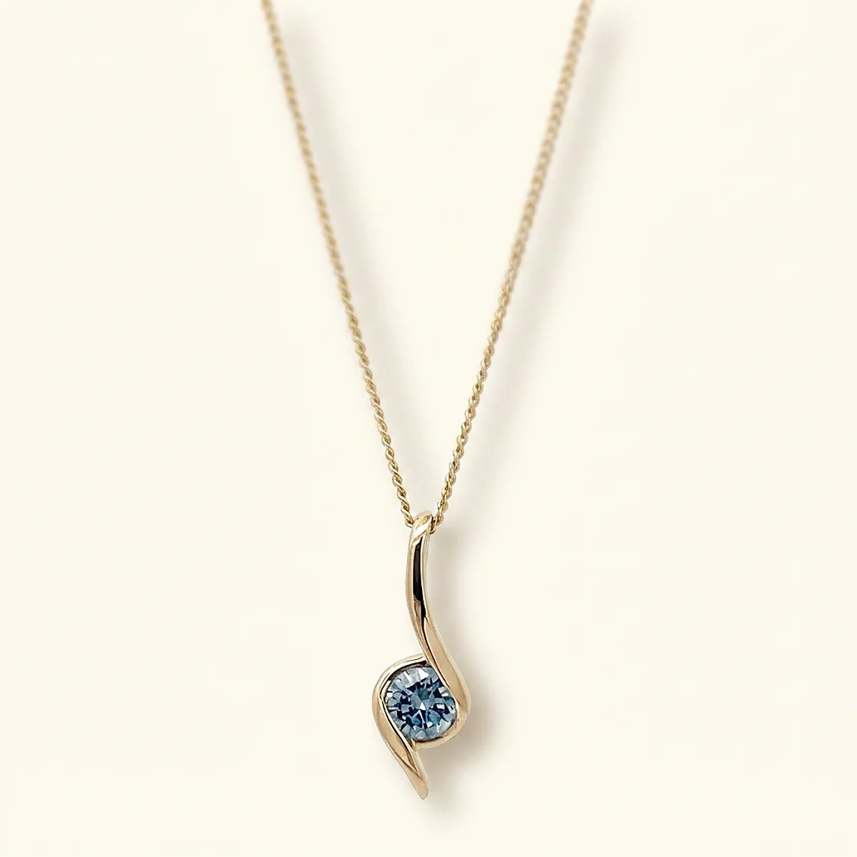 A .25ct blue round diamond on a yellow gold pendant, custom-designed by Eterneva to honor the remarkable Flor.