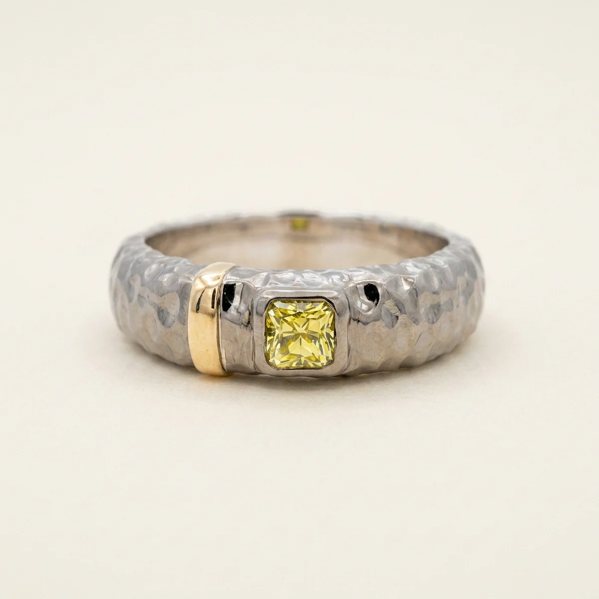 A .4ct yellow square radiant diamond on a mixed metal ring, custom-designed by Eterneva to honor the remarkable Mucci.