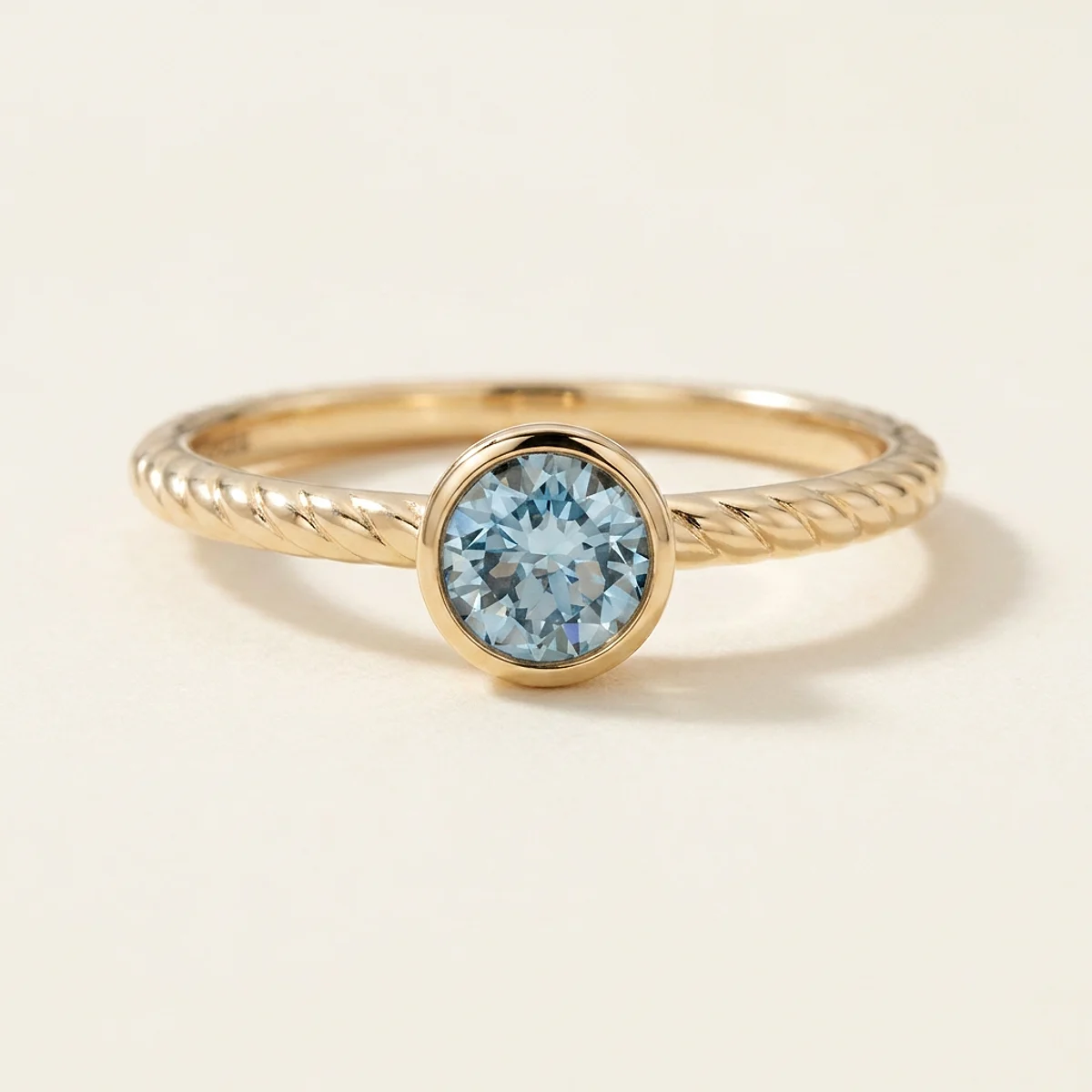 A .5ct blue round diamond on a yellow gold ring, custom-designed by Eterneva to honor the remarkable Reese.