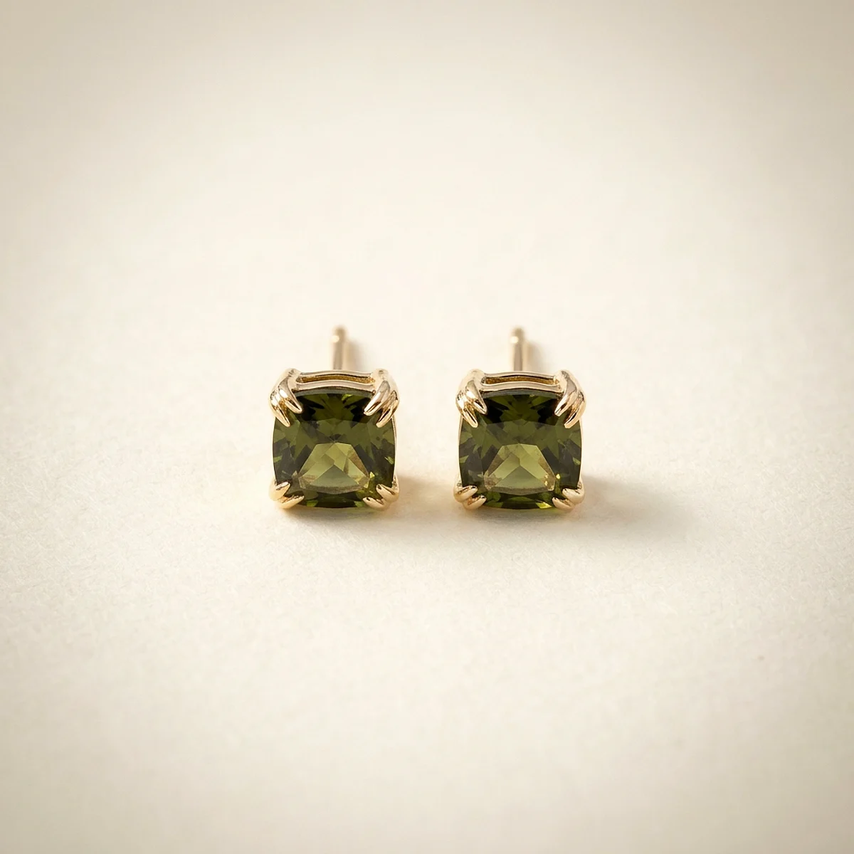A .5ct green cushion diamond on yellow gold earrings, custom-designed by Eterneva to honor the remarkable Tana.