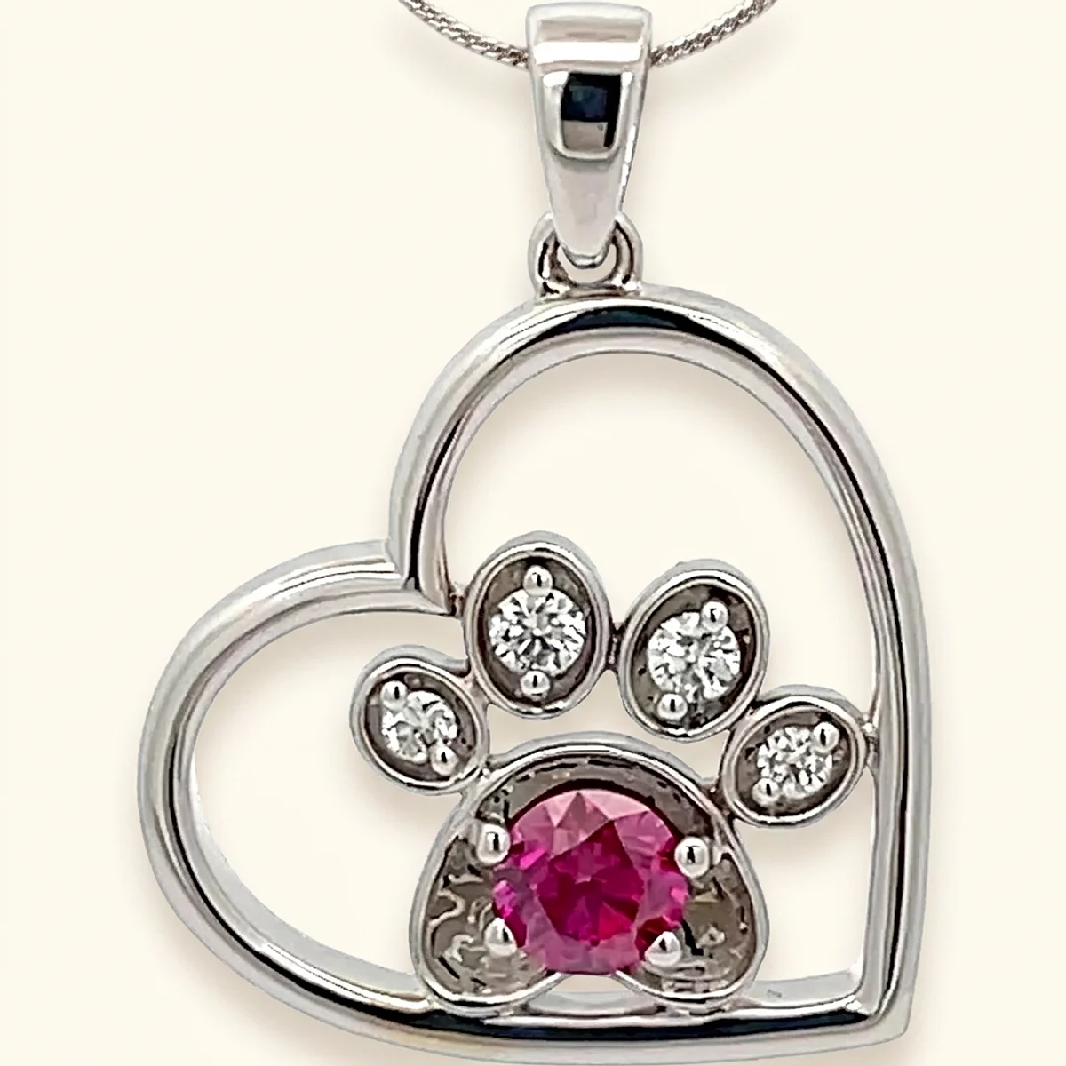 A .25ct red round diamond on a white gold pendant, custom-designed by Eterneva to honor the remarkable Teddy.
