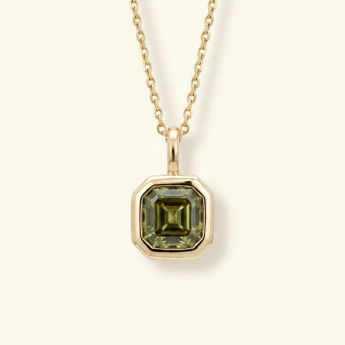A .4ct green asscher diamond on a yellow gold pendant, custom-designed by Eterneva to honor the remarkable Carlos.