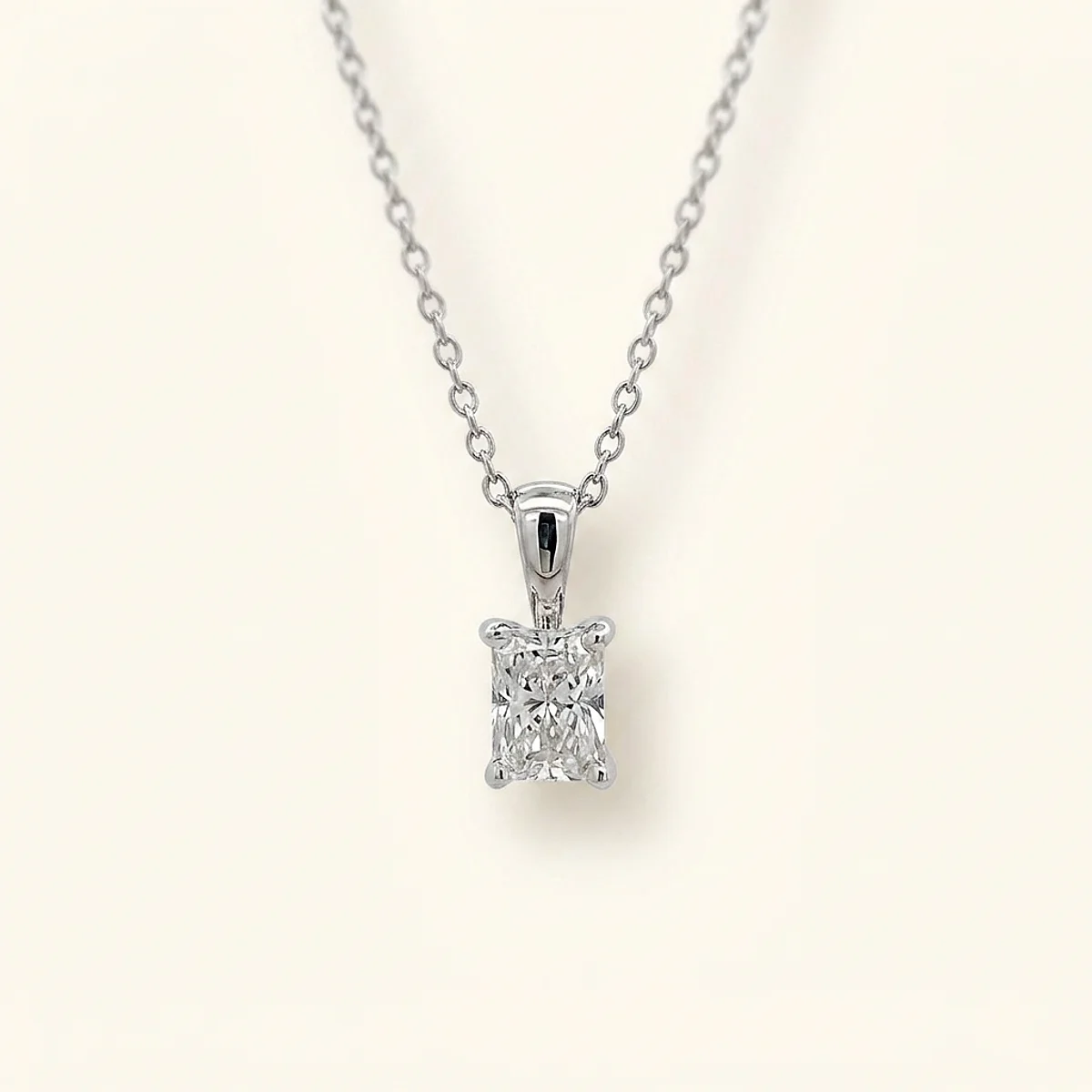 A .5ct colorless rectangular radiant diamond on a white gold pendant, custom-designed by Eterneva to honor the remarkable Neil.