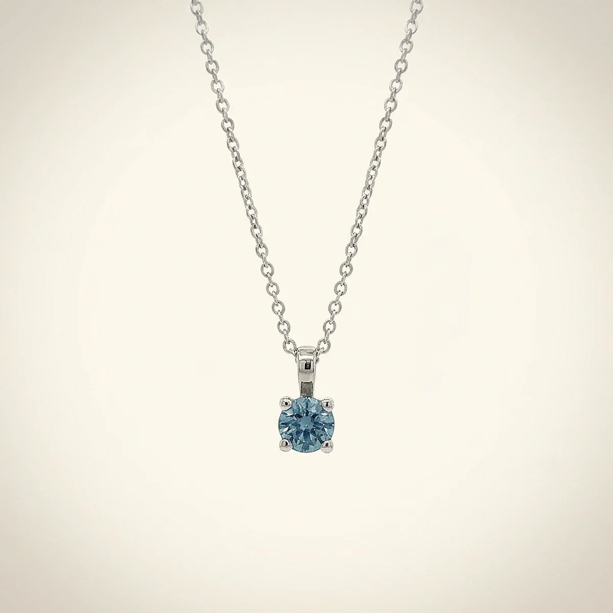 A .25ct blue round diamond on a white gold necklace, custom-designed by Eterneva to honor the remarkable Duke.
