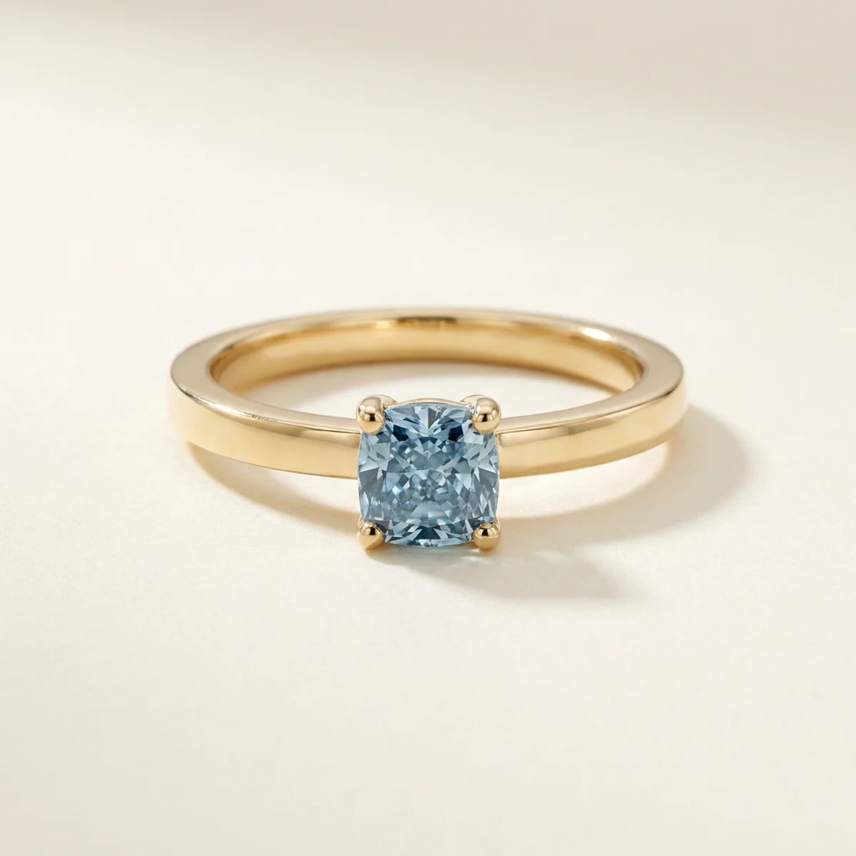 A .5ct blue cushion diamond on a yellow gold ring, custom-designed by Eterneva to honor the remarkable Clare.