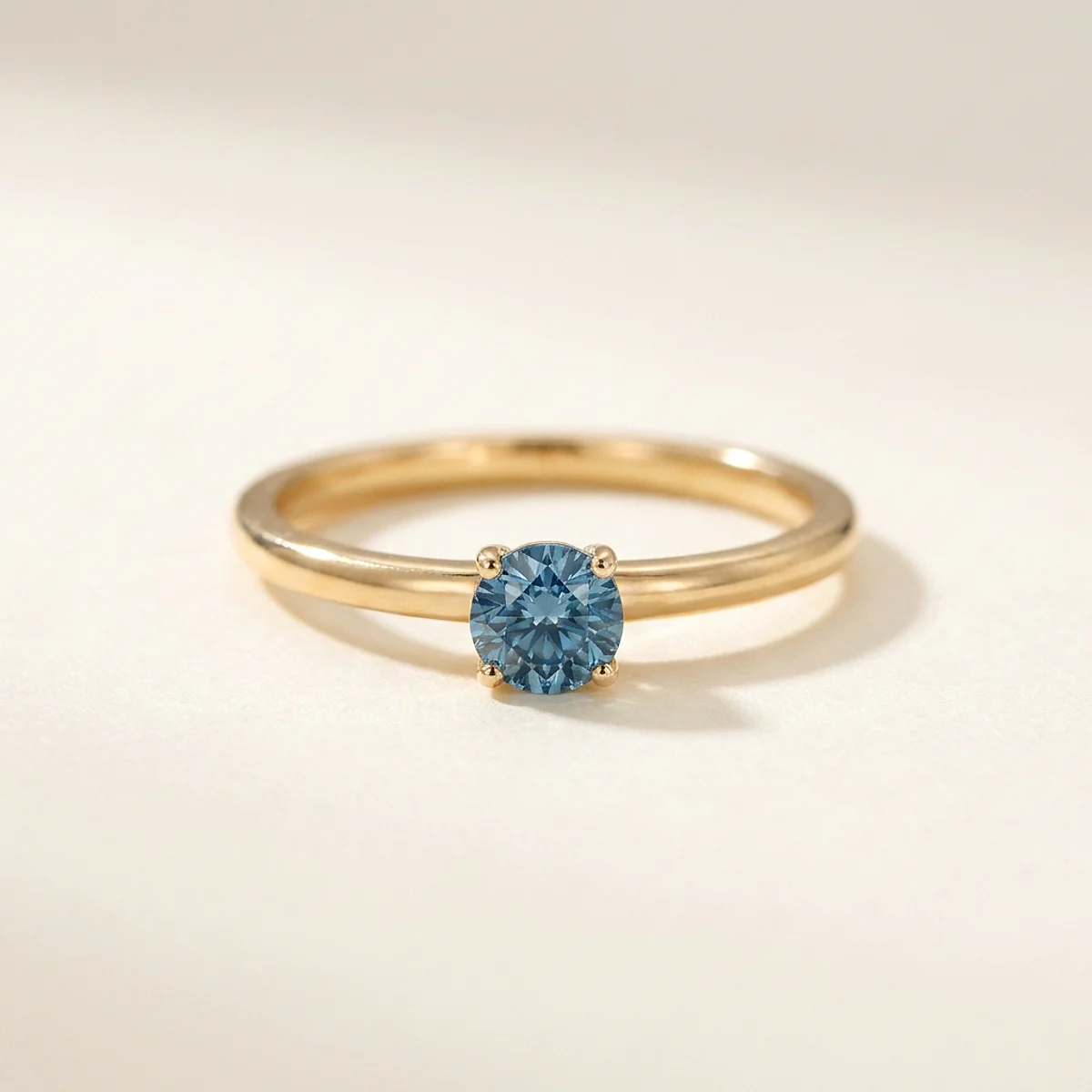 A .4ct blue round diamond on a yellow gold ring, custom-designed by Eterneva to honor the remarkable John.